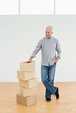 Mature man with boxes in a new house