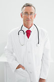 Confident male doctor standing in medical office