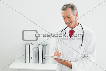 Doctor writing a report at the office