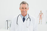 Smiling confident male doctor in medical office