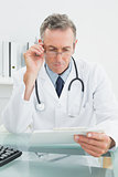 Doctor reading a report at medical office