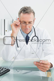 Doctor reading a report at medical office