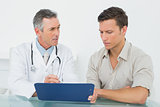 Doctor discussing reports with patient at office