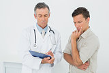 Doctor discussing reports with patient in office
