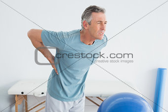 Man with lower back pain at the gym hospital