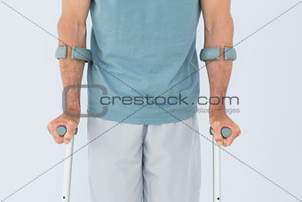 Close-up mid section of a man with crutches