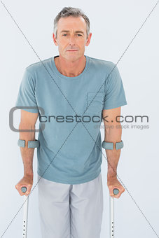 Portrait of a mature man with crutches