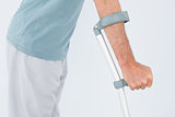 Close-up mid section of a man with crutch