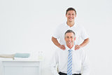 Male chiropractor and well dressed mature patient