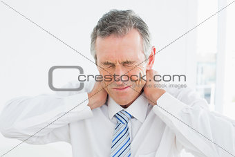 Close-up of a mature man suffering from neck pain