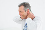 Side view of a mature man suffering from neck pain