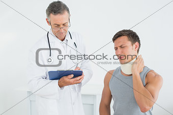 Male doctor listening to patient at medical office