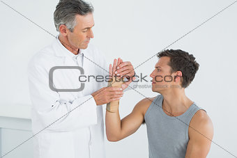 Doctor examining a young patients hand
