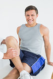 Portrait of a smiling man getting his leg examined