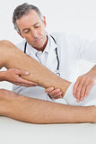 Close-up of a man getting his ankle examined