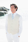 Groom smiling with hands in pockets