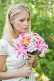 Calm bride holding her bouquet close