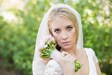 Peaceful bride holding her bouquet