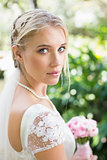 Blonde bride in a veil looking to camera