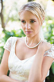 Smiling blonde bride in pearl necklace