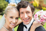 Attractive bride and groom smiling at camera