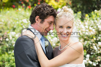 Romantic smiling newlyweds hugging each other