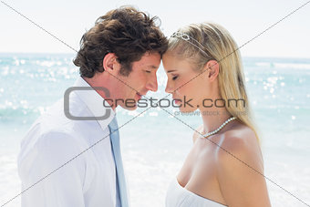 Content couple embracing each other on their wedding day