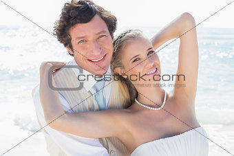 Newlyweds smiling at camera