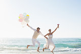 Newlyweds having fun holding balloons