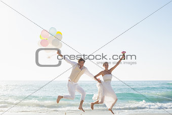 Newlyweds having fun holding balloons