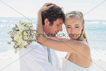 Romantic couple embracing on their wedding day