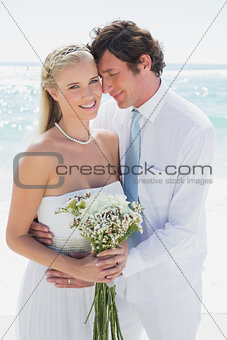 Content couple on their wedding day bride smiling at camera
