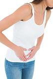 Close-up mid section of a casual woman with stomach pain