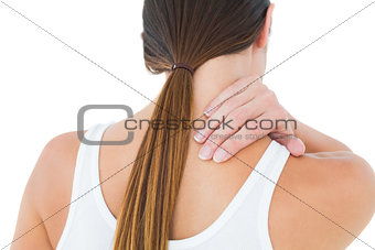 Rear view of a casual woman suffering from neck ache