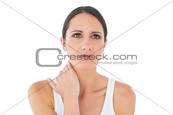 Close-up of a casual woman suffering from neck ache