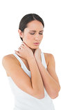 Close-up of a casual woman suffering from neck ache