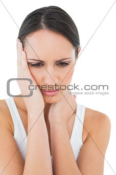 Close-up of a casual woman suffering from headache