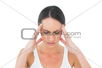 Close-up of a casual young woman suffering from headache