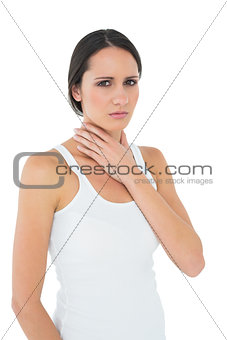 Portrait of a casual woman suffering from neck ache