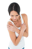 Close-up of a casual woman with shoulder pain