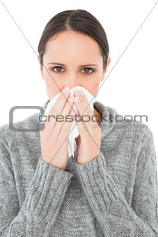 Close-up portrait of a casual woman suffering from cold
