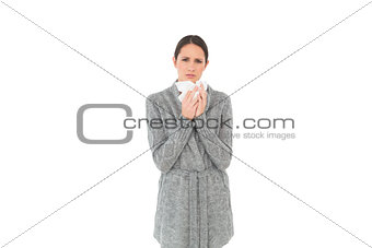 Portrait of a casual young woman suffering from cold