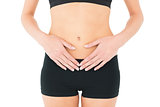 Close-up mid section of a fit woman with stomach pain