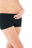 Close-up mid section of a fit young woman in black shorts