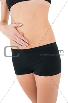 Close-up mid section of a fit woman in black sportswear