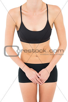 Mid section of a fit woman in black sportswear