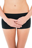 Close-up mid section of a fit woman in black shorts