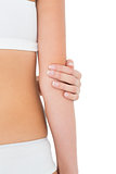 Close-up mid section of a fit woman with elbow pain