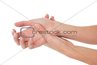 Close-up of a young woman touching her wrist