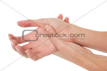 Close-up of a young woman touching her palm